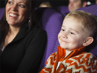 A mother and son watching a planetarium showing