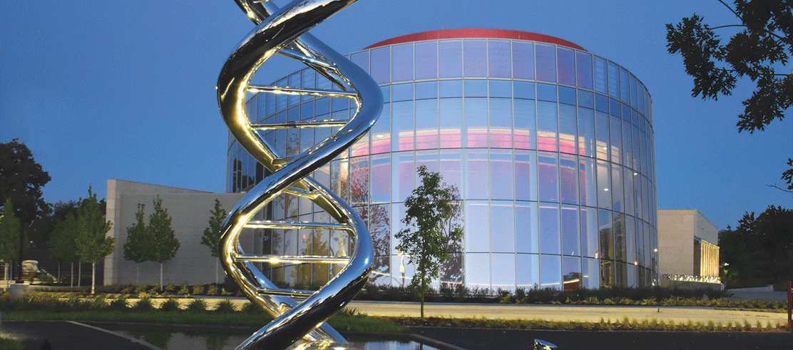 The DNA Sculpture in Discovery Park with the Discovery Center in the background